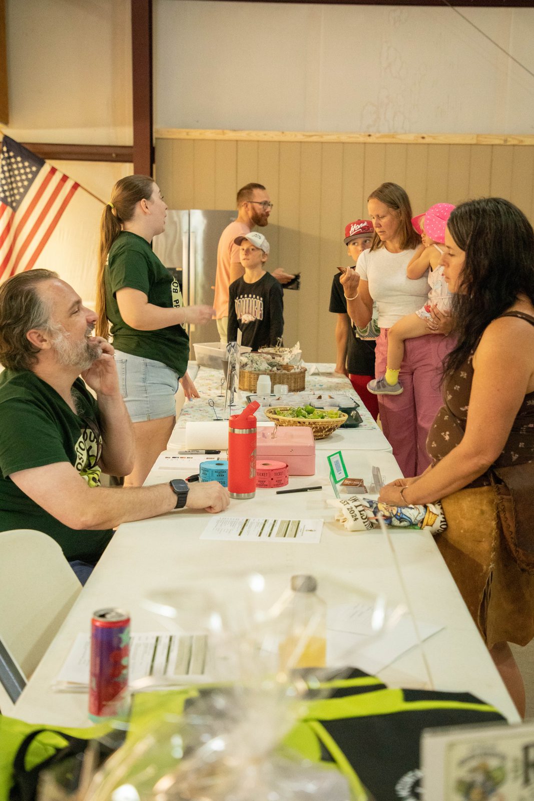 Busy ticket table with families and pawpaw samples